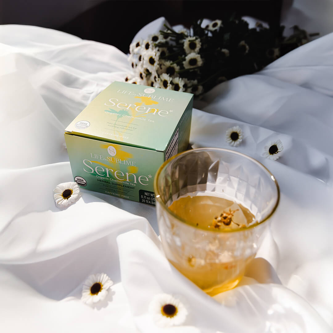 Organic chamomile tea packaging with glass of steeped serene tea